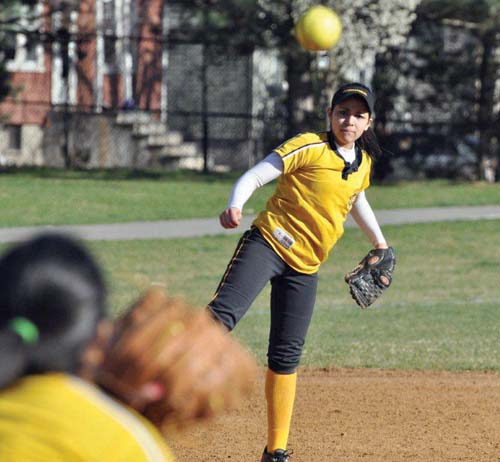 Sarai Alburez of the Boston International High School team warmed up with a teammate on Tuesday afternoon as Hemenway Park became alive with the sights and sounds of spring softball. The contest at the playground on Adams Street pitted International against East Boston High School, and Eastie prevailed.	Photo courtesy Richard Johnson/SonofCodmanSquare.com